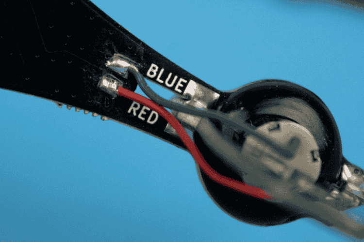 Motors inserted into grommets, wire colour markings visible PCB Bottom